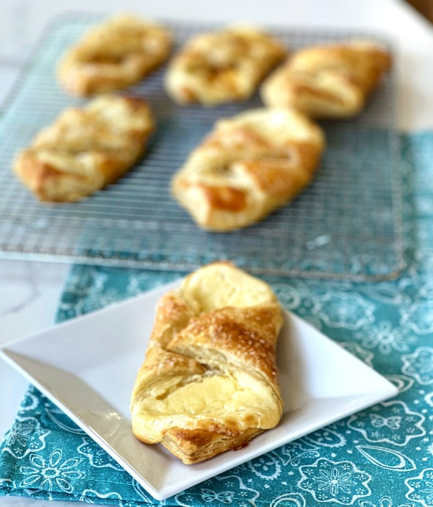 A box of frozen puff pastry makes the easiest, and most delicious homemade cream cheese Danish pastry! You won't believe how fast and easy this is.  Your family or brunch guests will think you slaved for hours, making these.  It's our little secret!