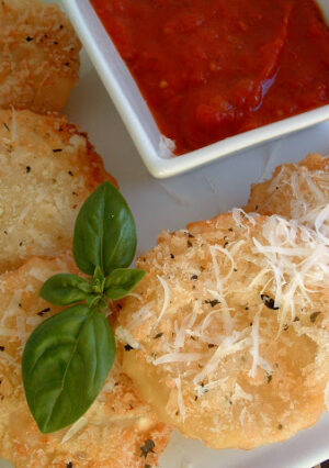 Ravioli, filled with ricotta cheese are dipped in buttermilk and coated with panko crumbs. They are deep-fried to a crunchy golden brown and served with a delicious Marinara Sauce. What's not to love? This appetizer is surprisingly light. It's also very easy to make ahead, and then to deep fry once your guests have arrived.