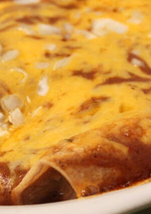 Enchiladas with Chili Gravy and onion and melted cheese.