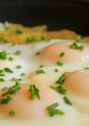 Rösti is a German/Swiss traditional "hash" potato dish. The secret to making this is to squeeze out as much of the moisture from grated potatoes as you can. With this version, shredded onion was added, then cooked until golden brown. Once cooked, add fresh eggs on top for a hearty breakfast. Rösti are a delicious side dish for any kind of meal, including dinner.