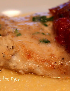 This Chicken Breast with a Walnut Aillade elevates boring plain chicken into an easy gourmet meal! What is a Walnut Aillaide Sauce? It's a garlic sauce. This sauce is made with walnuts, walnut oil, and, garlic and fresh parsley. With a food processor, it takes a minute or two to make and it turns into a creamy emulsion. Chicken is marinated in plain yogurt, and then pan seared and topped with this sauce. It's a quick and delicious meal. As an optional condiment, I topped this with my savory tomato jam recipe atop a mound of creamy polenta. Restaurant quality, for sure!