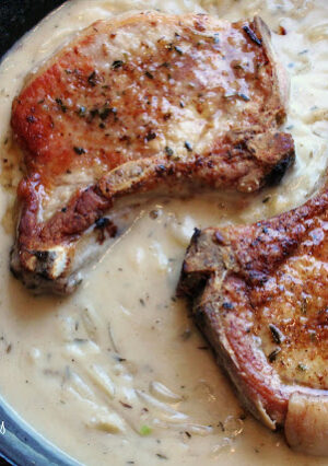 Smothered Pork Chops with a Buttermilk Onion Gravy is comfort food, at it's best. Pork chops are seared and roasted and smothered with plenty of onions. A quick pan sauce is made with buttermilk and chicken broth, and you have a dinner that is easy enough for a work night dinner!