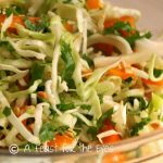 This coleslaw has an Asian Twist by making a quick and easy dressing with rice vinegar, fish sauce, lime juice and a few other aromatics. (Don't let the idea of "fish sauce" scare you-- it works great in this recipe. The coleslaw is finished off with chopped peanuts and cilantro and it is absolutely delicious!