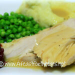 Turkey Breast with gravy, mashed potatoes and peas.