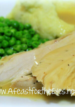 Turkey Breast with gravy, mashed potatoes and peas.