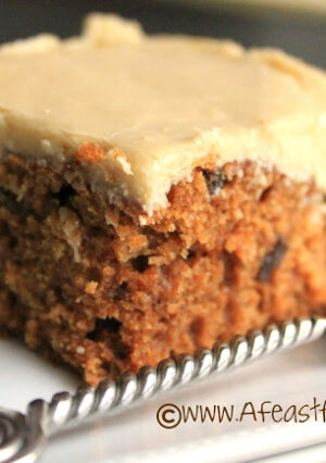 A slice of applesauce cake with a fudgy frosting