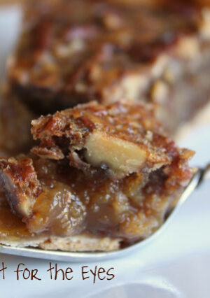 A slice of pecan pie, resting on a fork.