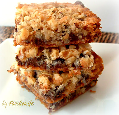 These classic bar cookies  have magic layers in them. A buttery graham cracker crust and a chewy and gooey center filled with nuts, coconut and chocolate.  Wowza!
