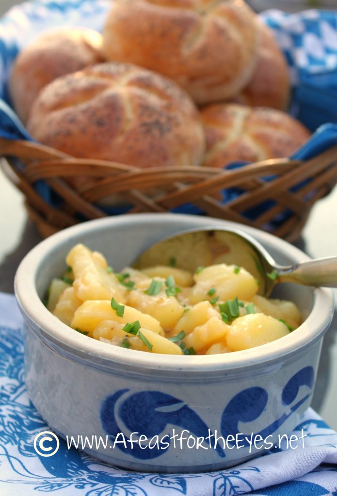 This potato salad recipe tastes just like what is was served to us whenever we visit Bavaria and Austria.  Broth, vinegar, mustard and onion are simmered and then poured over warm, sliced cooked potatoes--with just a small amount of vinegar and oil. Served at room temperature, with German sausages or cold cuts, this is my childhood comfort food at its best.