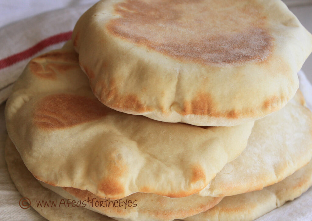 This Greek-Style Pita bread is surprisingly easy to make at home and so much better than the dry and tough versions that comes in bags from the grocery store. The dough is a breeze to work with, and puffs up beautifully in the oven, then relaxes to a "pita pocket" bread that has endless "stuffing" possibilities. We particularly enjoy this bread with homemade Ground Lamb Gyros. 