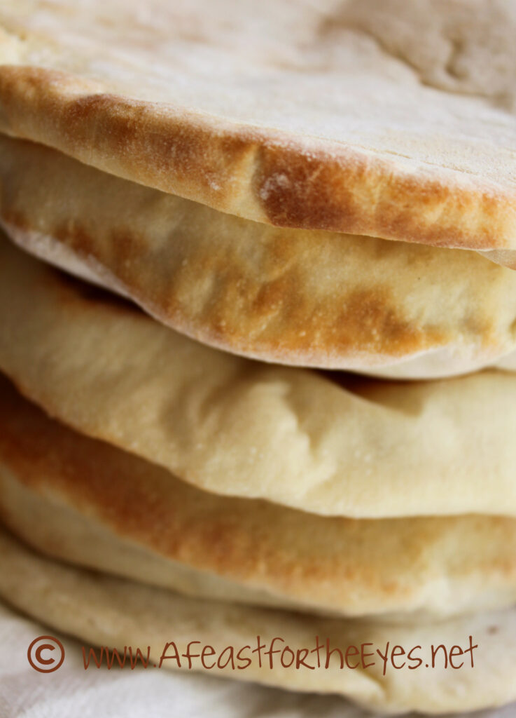 This Greek-Style Pita bread is surprisingly easy to make at home and so much better than the dry and tough versions that comes in bags from the grocery store. The dough is a breeze to work with, and puffs up beautifully in the oven, then relaxes to a "pita pocket" bread that has endless "stuffing" possibilities. We particularly enjoy this bread with homemade Ground Lamb Gyros. 