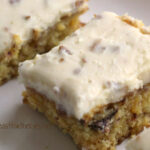 A slice of Pineapple Pecan cake with a Pecan Cream Cheese Frosting.