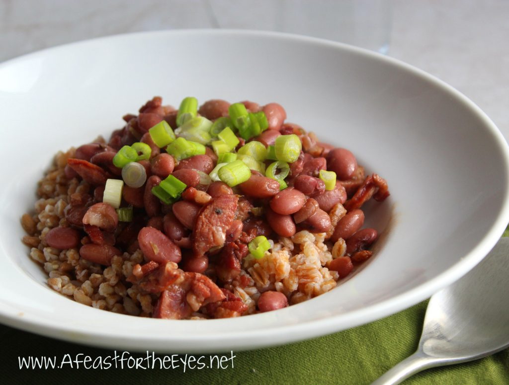 Red beans and rice is a Louisiana Creole dish with red beans, vegetables, spices and pork bones, cooked together slowly and served over rice. Meats such as ham, sausage, and tasso ham are also frequently used in the dish.  Since I don't live in the South, not all of the traditional ingredients (such as Camellia brand dried red beans nor tasso ham) isn't readily available. I took the liberty of using  substitutes.  The end results were flavorful beans reminiscent of my visits to New Orleans. The flavors of pork and spice were spot on perfect!  Oh, and instead of traditional rice, I used farro grain since it's healthier than rice.  