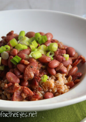 A bowl of red beans, garnished with green onion.