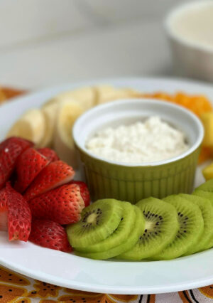 Fresh fruit plate with a cottage cheese dip and banana sauce.