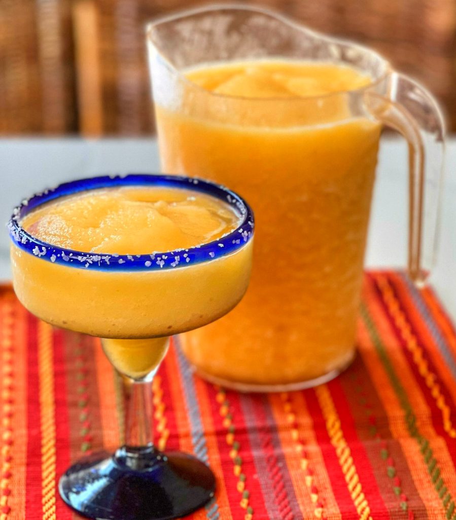 Enjoy these Frozen Peach Margaritas year round! They are one of our favorite "Al Fresco" cocktails on a warm day, with a bowl of guacamole and chips. Olé and Cheers!