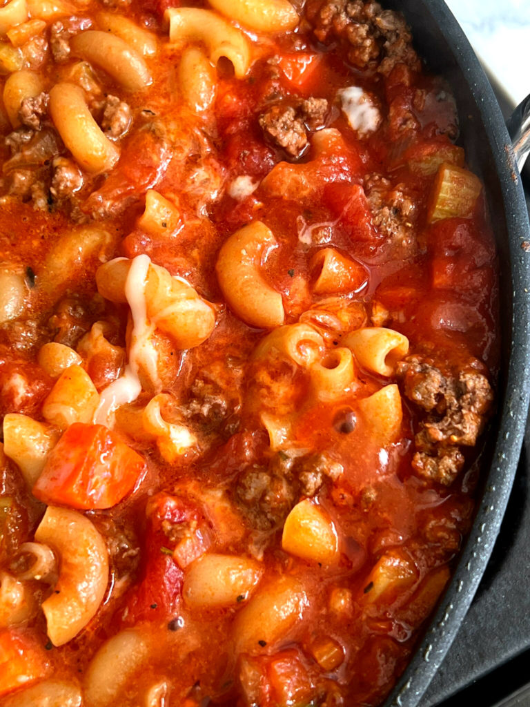American Goulash is a fast and easy one dish wonder of cooked ground beef, vegetables, pasta and cheese. The beauty of this dish, is that this is all made in one skillet! American Goulash has no relationship to Hungarian Goulash. I want to clear the air on that, straight up!  This recipe is versatile,  where you can add vegetables and spices of your personal preferences.  American Goulash can be a perfect freezer meal that your family will love. 