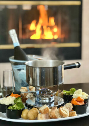 This Swiss Cheese Fondue Recipe is so easy to make. You don't even have to own a fondue pot! In a pot, you'll combine dry white wine and few other aromatics. Gently melt Gruyere and Swiss Cheese until smooth. I transfer the melted cheese mixture into my fondue pot, with a "sterno" to keep it warm. Chunks of bread and "al dente" vegetables makes this a fun Fondue Party at home-- for a lot less cost than at a fancy restaurant.