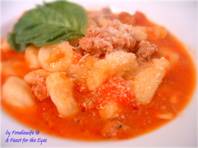 This Homemade Sardinian Semolina Ciccioni (Gnocchi) with an easy Sausage and Tomato Sauce is heavenly! Each golden "nugget" is a dumpling (gnocchi) made with semolina flour, and saffron (for color). The pasta is a little time-consuming to make, but it's simple enough that even kids can do it!