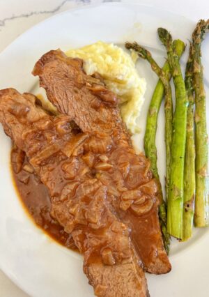 This Onion Braised Beef Brisket yields melt-in-your-mouth tender beef, smothered in an onion gravy that is loaded with delicious flavor. The brisket is slow braised the day before serving, that allows the flavors to build overnight. The next daythe brisket is gently warmed in the oven, while the onion gravy is heated separately. Making this one day ahead made for less work in the kitchen, on the day of our holiday dinner. Our guests loved this recipe as much as we did!