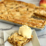 This Flat Apple Pie is truly the best! Instead of using a round pie plate, the crust is pressed into a sheet pan -- making this a perfect dessert to feed a crowd. The crust is buttery and tender. The pie filling has notes of fall spices like cinnamon, all spice and nutmeg. If you love golden raisins as much as we do, toss those in the filling, too. Coarse sugar gives the pie a nice crunch. Polish this off with an optional simple glaze and you have the perfect dessert.