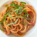 A Bowl of Spaghetti with Tomato sauce and a basil garnish