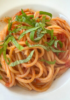 A Bowl of Spaghetti with Tomato sauce and a basil garnish