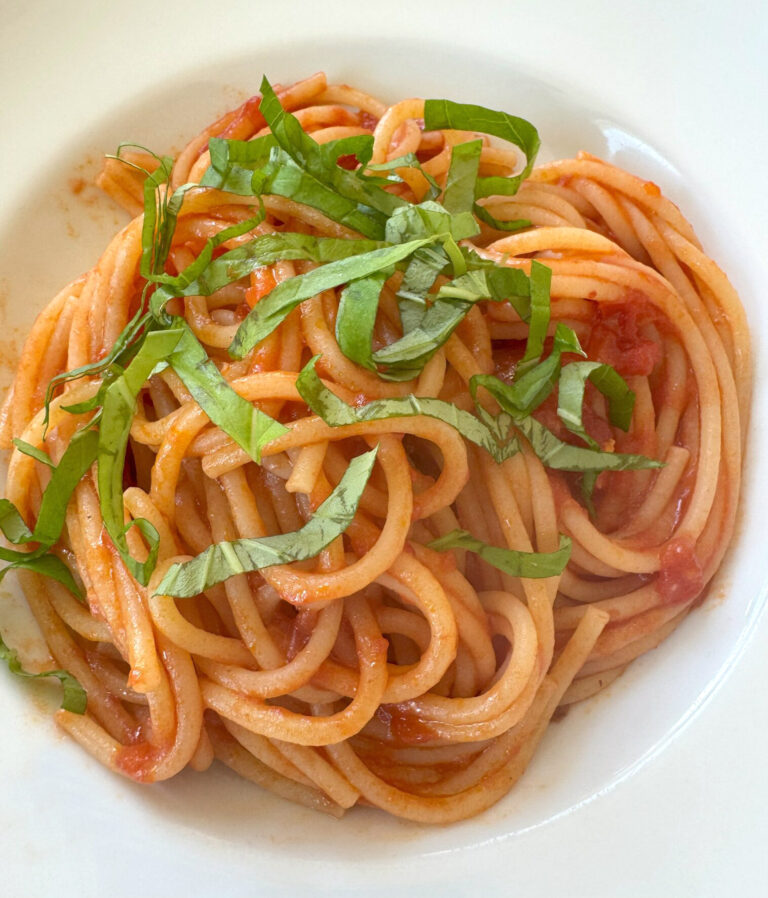 A Bowl of Spaghetti with Tomato sauce and a basil garnish